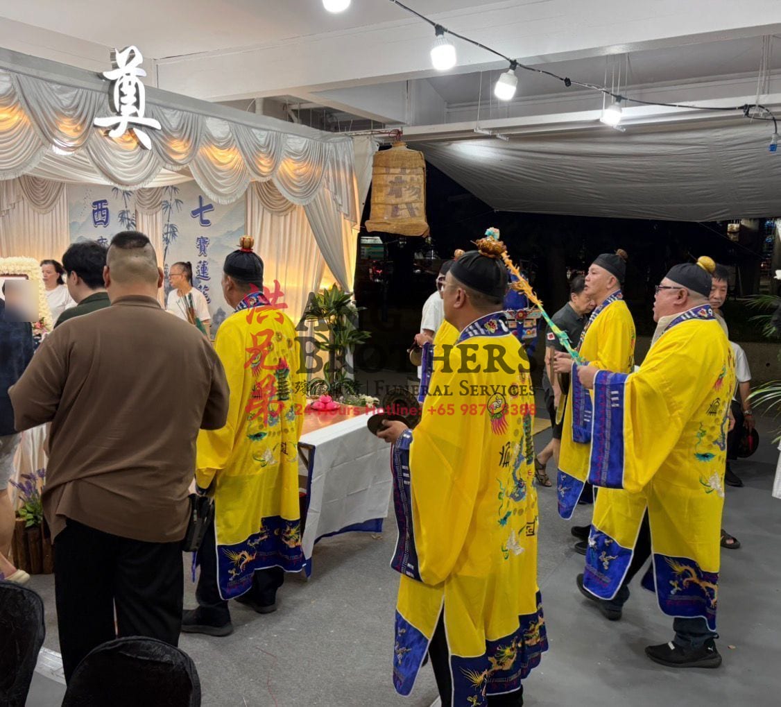Taoist priests in yellow robes leading the rites