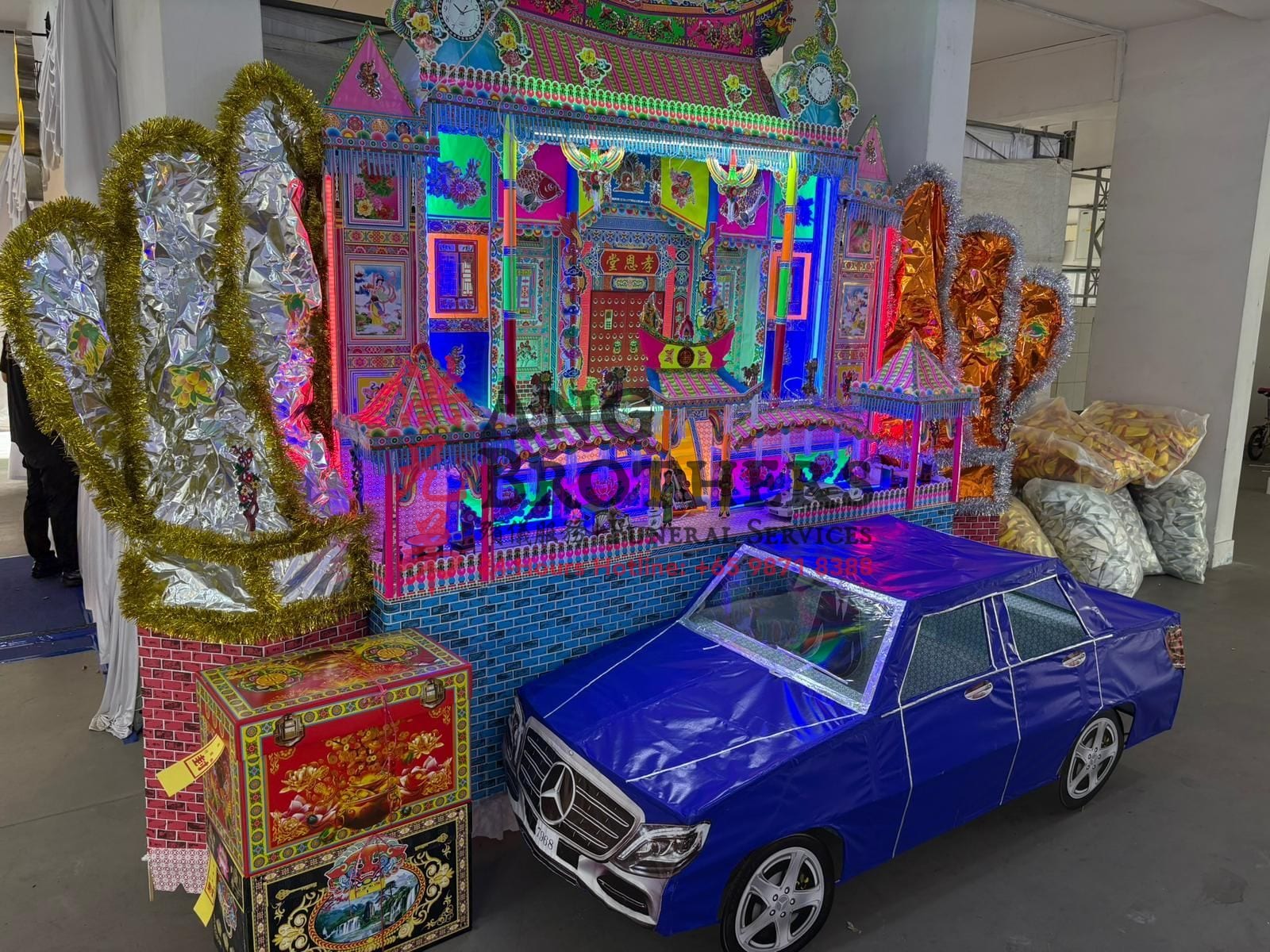 Paper mansion with a paper car for a Taoist funeral